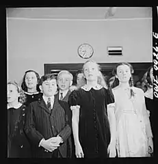 Elementary school students singing America the Beautiful during a radio broadcast to Latin America