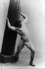 Eugen Sandow holding pillar