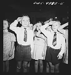 First graders in public school saluting the flag