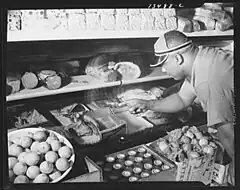Children waiting in line to buy defense stamps at public school