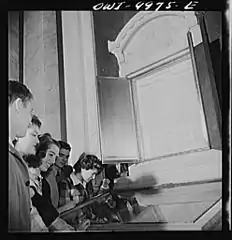 Students examining the U.S. Constitution, with the Declaration of Independence above them