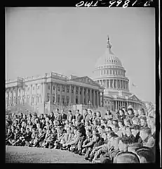 Students posing for a group photograph with the Capitol in the background