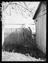 Woman at her back gate