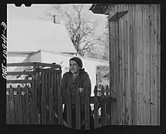 Woman at her back gate
